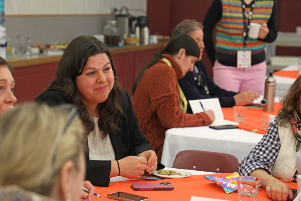 Groups of people discussing at tables.